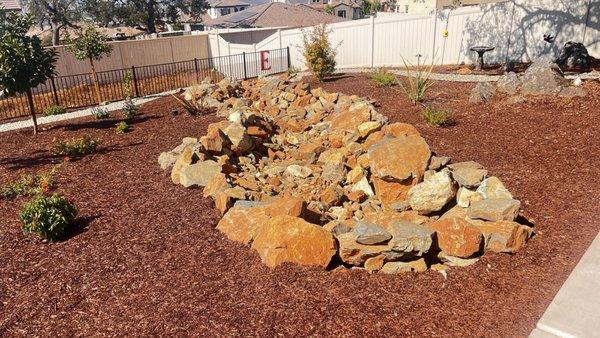 Dry creek bed. All rocks were repurposed. Looks very natural for our area.