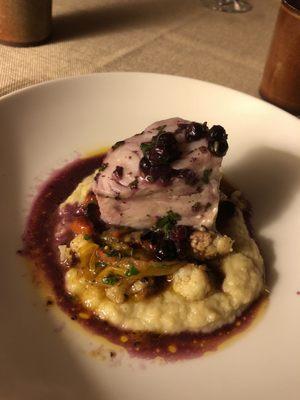 Poached Alaskan black cod with celeryroot puree, roasted cauliflower, tomato confit, roasted red pepper, and huckleberry beurre blanc