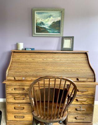 Antique desk salvaged as a focal point with art curated from a local antique shop.