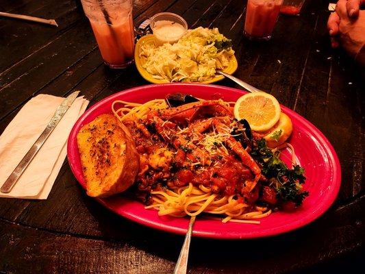 Seafood pasta, garlic bread and a side salad with Italian strawberry soda.