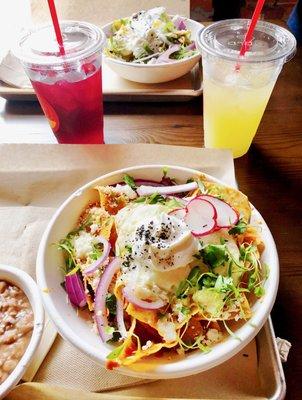 Red Chilaquiles in front, Green Chilaquiles in back. Both are spicy. Left drink is Jamaica and right is Pineapple.