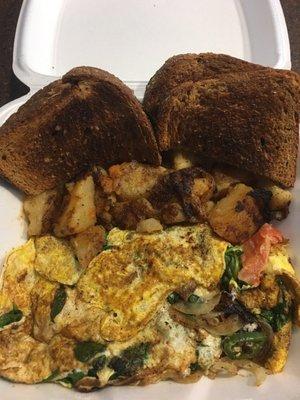 Huge egg white omelette w/ onions, tomatoes, jalapeños, and spinach. The platter includes toast, potatoes and coffee for $8.