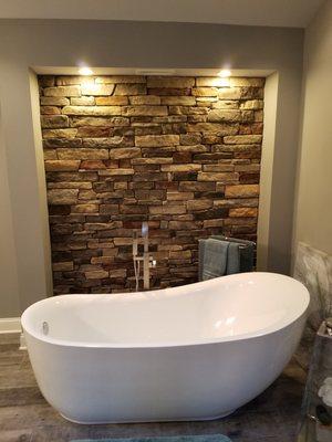 Free Standing Tub With Lighted Stone Back Drop