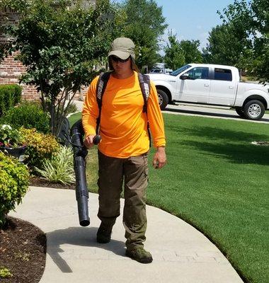 Cleaning off sidewalks after mulching.