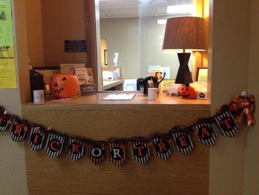 Fun and whimsy. "Trick or Treat" lit banner greets new clients.