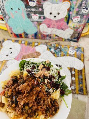 Spinach arugula micro sprouts salad with lamb bolognese pasta