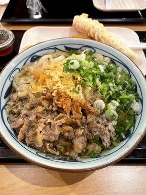 Regular sized Beef Udon with extra spicy seasoning, green onions, and tempura flakes