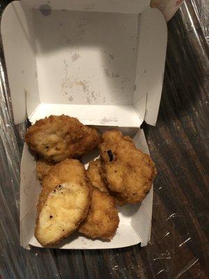 The chicken nuggets are under cooked and yet have burnt prices all over them and are slimy