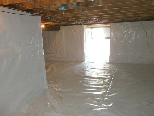 Completely wrapped floor and concrete walls, and sealed the top with a plastic cover to stop air from leaking up