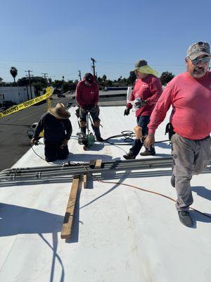 CREW WORKING ON A BRAND NEW TPO ROOF SYSTEM