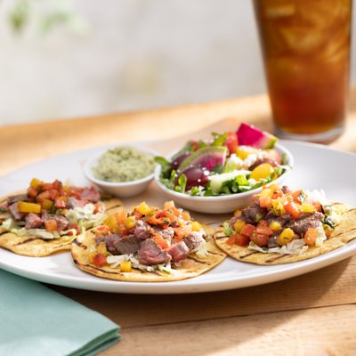 Wood-Grilled Steak Tacos—taco slaw, pico de gallo, cotija, avocado, lime