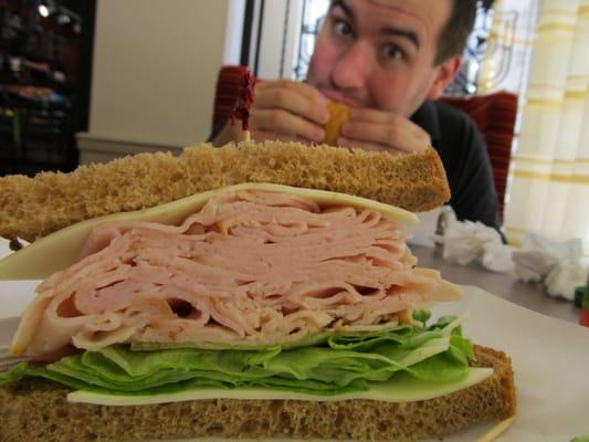 Eric P. enjoying lunch as I photograph my towering turkey sandwich.