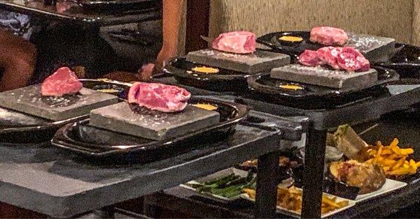 Raw steaks delivered to table on 755F stone