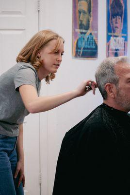 Mandy cutting a customer's hair at Nic Grooming Barber Shop Sansom Street.