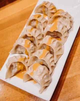 Steamed Pork Momo with classic mild sauce.