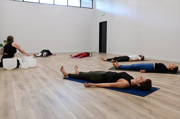 Enjoy a relaxing sound bath in a group yoga therapy setting.