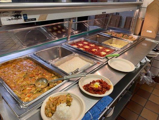 Hot entree station serving Thai Tofu with Peanut Sauce (left), Shakshuka (middle), and Quinoa and Wild Rice Stuffed Peppers (right).