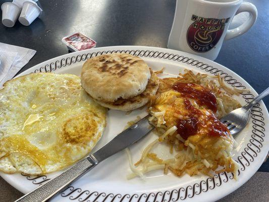 Over medium eggs, hash browns and a biscuit