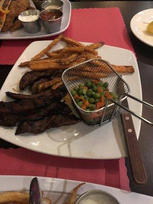 Marinated skirt steak, with peas and carrots, sweet potato fries