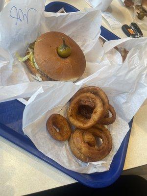 Cheese burger with jalapeños and onion rings