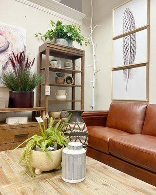 Brown leather couch with coffee table and shelves