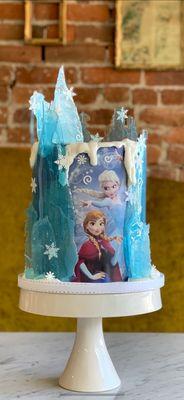 Frozen birthday cake with sugar art.