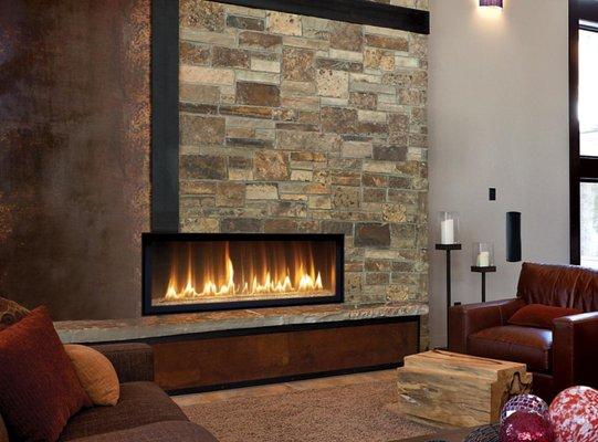 Rectangular opening with wide Natural Gas burner under a stocked stone finish front wall.