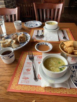 Fried dumplings, egg drop soup, tea, noodles and duck sauce