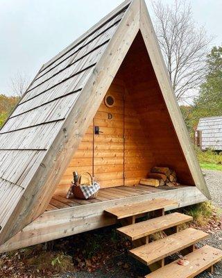 One of the lushna cabins with a breakfast basket waiting outside