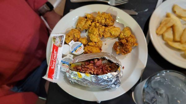 Fried oysters with a loaded baked potato.