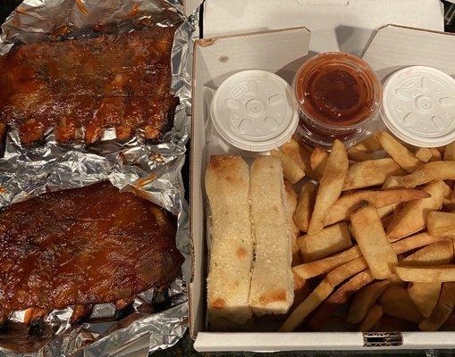 Slab of ribs comes with coleslaw, fries, and bread sticks. Requested extra sauce.