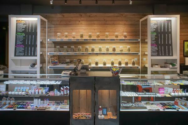 Looking straight on at the counter and flower shelf in TOKYO STARFISH Dispensary SE 3rd St, Bend, OR 97702 location.