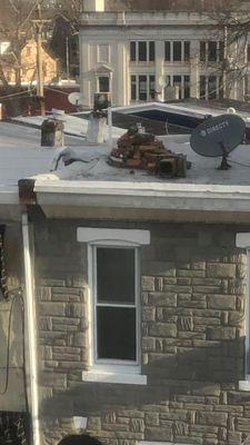 Bricks from my neighbor chimney placed on my roof!