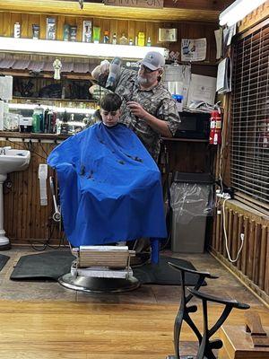 In the barber's chair.