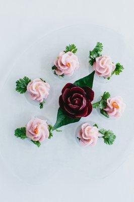 Steamed tea rose dumplings with caramelized palm sugar, minced chicken, ground peanuts, and pickled radish