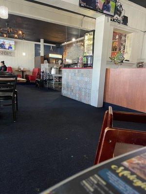 Cashier area and lady making tortillas