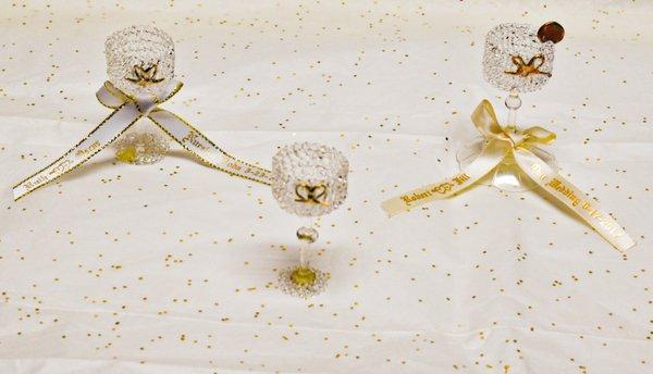 Miniature Crystal Glasses with a Gold Bow which may be used as party favors, along with personalized ribbons which we make to order.