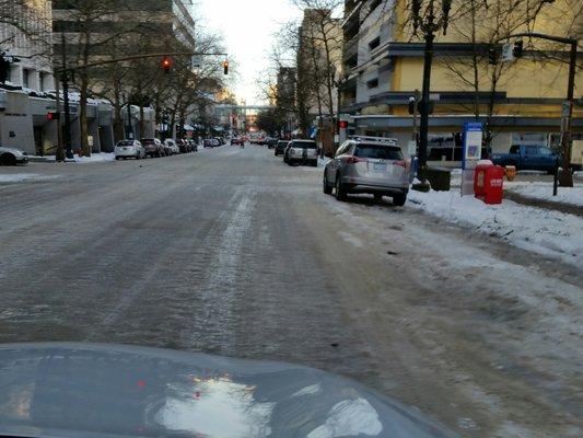 Days after the snow storm the downtown city streets are treacherous for vehicles pedestrians and public transportation.