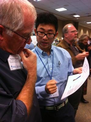 A JRI student explaining his work to a scientist at the 2013 WRRC conference in Tucson Arizona.