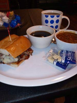 Half French dip sandwich in a side of chili