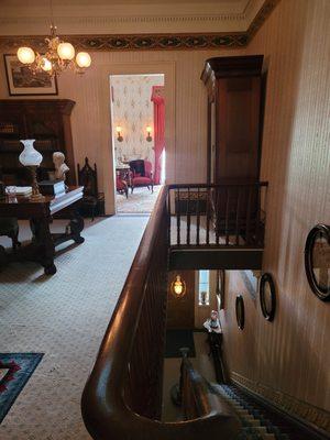 The view through the study into a small bedroom (upstairs) and the vestibule (downstairs).