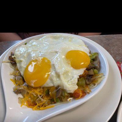 Veggie skillet with two eggs.