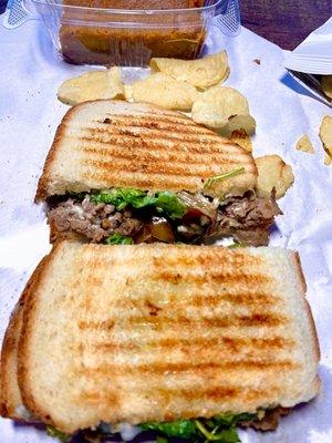 The Stake Out Sandwich - shaved steak, Gorgonzola spread, caramelized onions, arugula & grilled like a panini