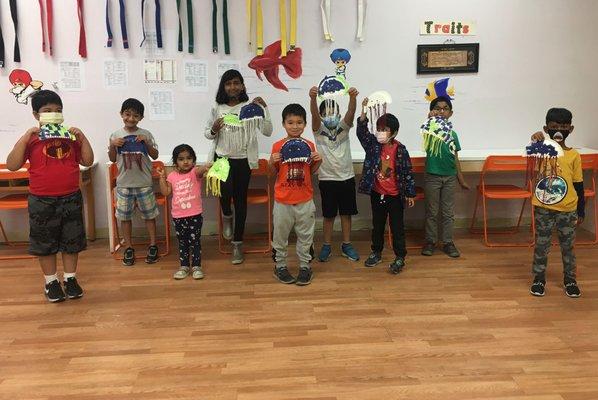 Posing with their craft work during summer camp.