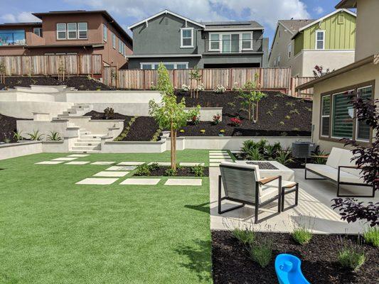 Synthetic Turf With Concrete Staircase and Stucco Retaining Walls