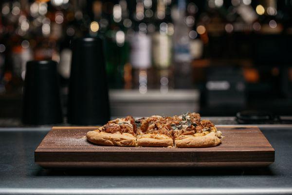 Smoked Chicken & Gruyère Flatbread, Mustard Vinaigrette, Apple & Sage Delicious combination of flavors on a crunchy, chewy flatbread.