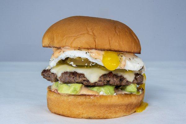 Chipotle Avocado Burger impossible patty, white american cheese, avocado, pickled jalapeños, cotija cheese, fried egg, chipotle aioli