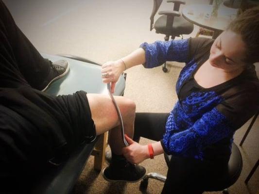 Dr. Michelle Friedman performing the Graston technique on a patient. Graston is a myofascial release method.