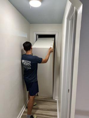 Ben and Gregory fitting wardrobe through tight spot!