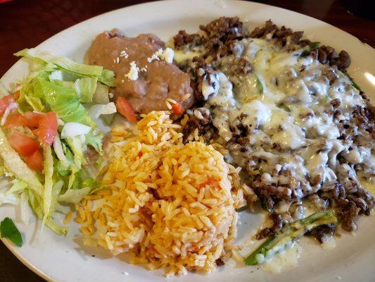 Asada con rajas y queso.  Jalapenos.  Comes with rice, beans, lettuce, tomato.